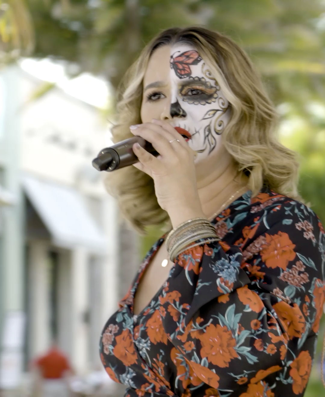 Stella Beat lead singer Wida Guzman performs with her face painted at a Cinco de Mayo Street Party concert on the Promenade at Sunset Walk.