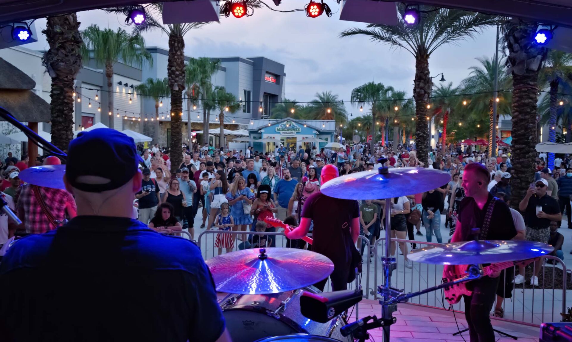 Live band performing on the Promenade Plaza Stage to a large crowd.