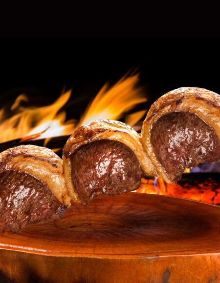 Steak on a skewer over a flame at BR 77 Brazilian Steakhouse.