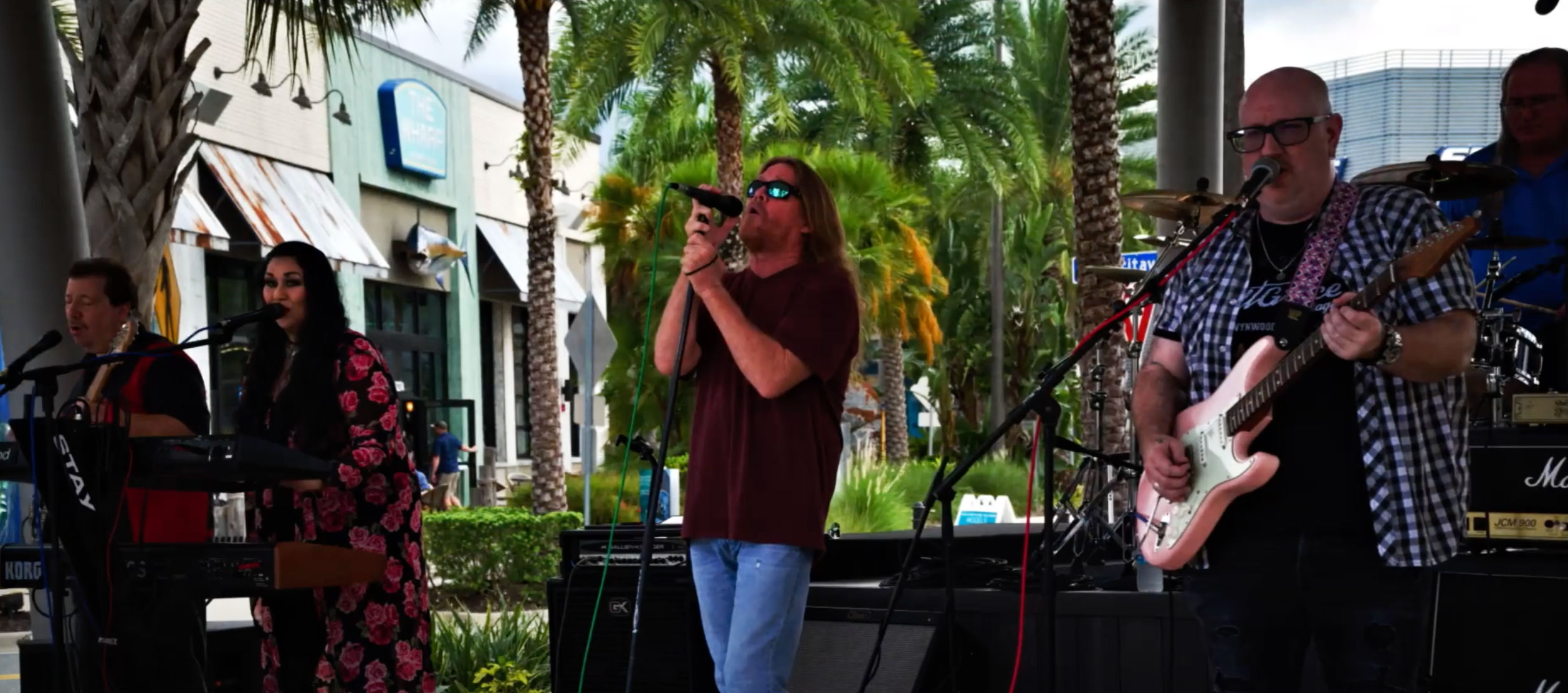 The band Bar Fly performing at the Sunset Walk 2022 Battle of the Bands