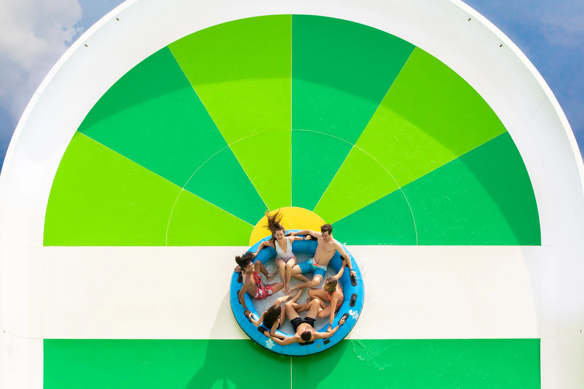People in a large tube riding the Hashtag Heights vertical water slide at Island H2O Water Park