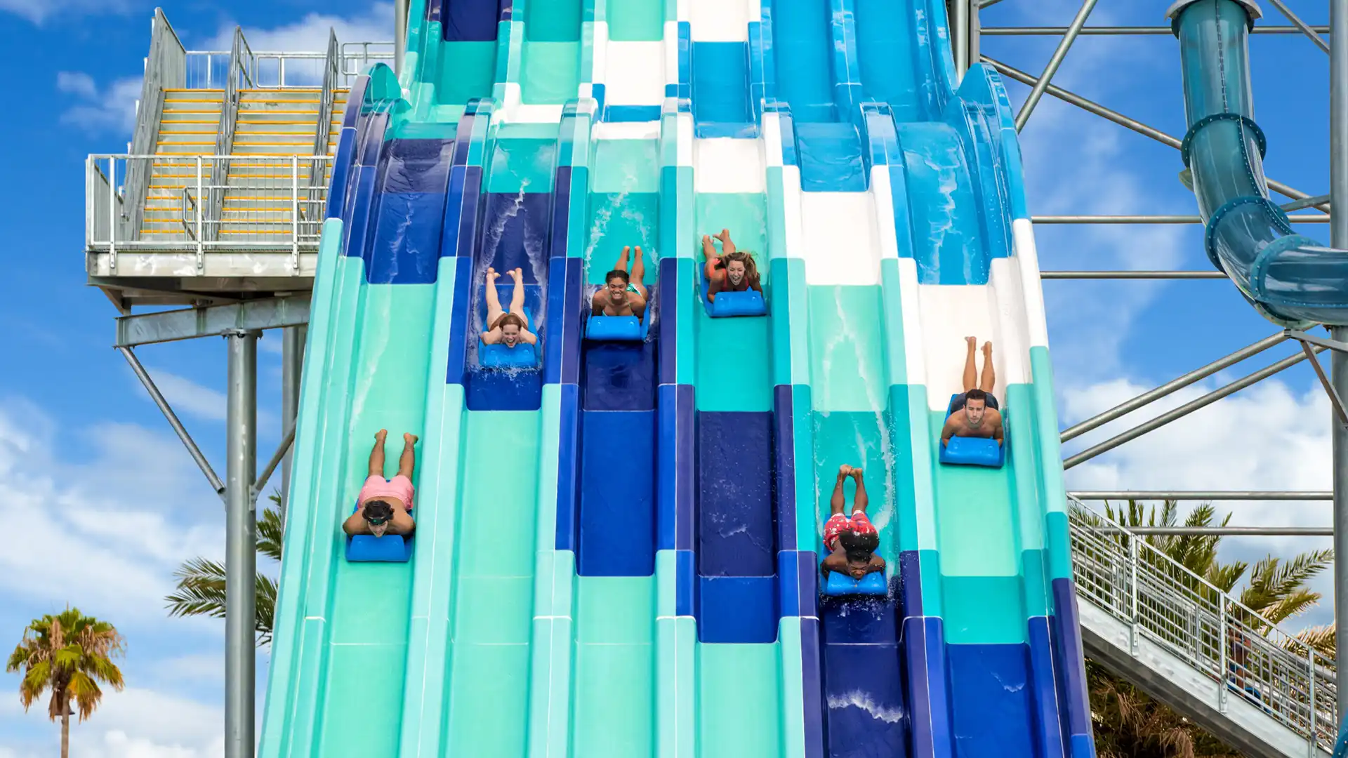 People riding the Reply Racers water slide at Island H2O Water Park