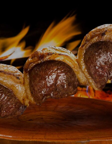 Steak on a skewer over a flame at BR 77 Brazilian Steakhouse