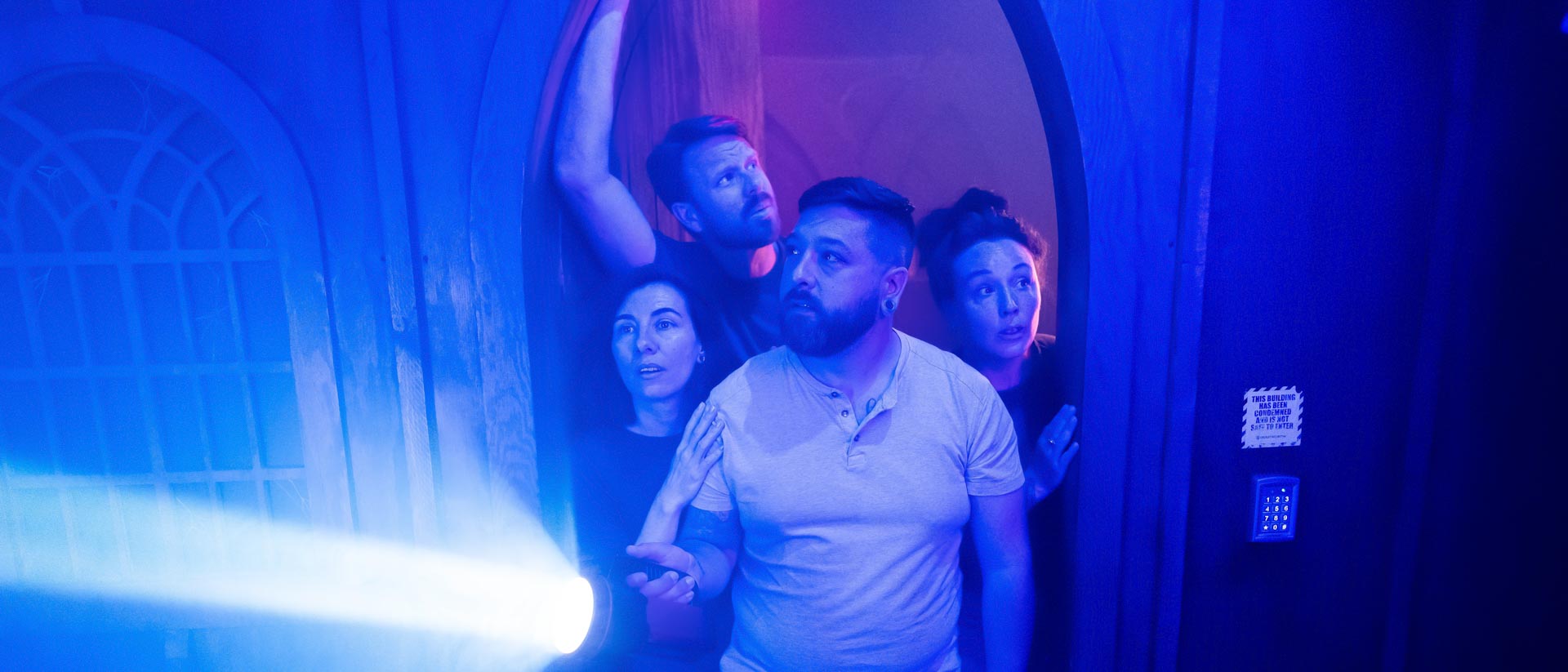 Group walking into a spooky themed escape room at Escapology