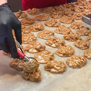 Sheet of pre-baked pralines at River Street Sweets • Savannah’s Candy Kitchen