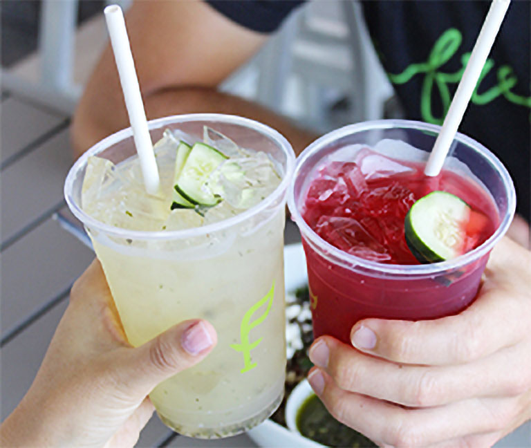 Hands raising cups of SoFresh drinks in a toast