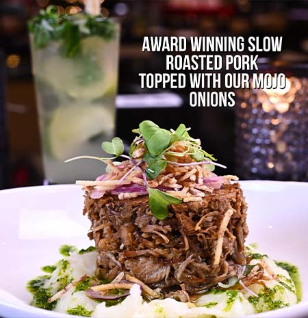 Estefan Kitchen Orlando’s award winning slow roasted pork topped with mojo onions