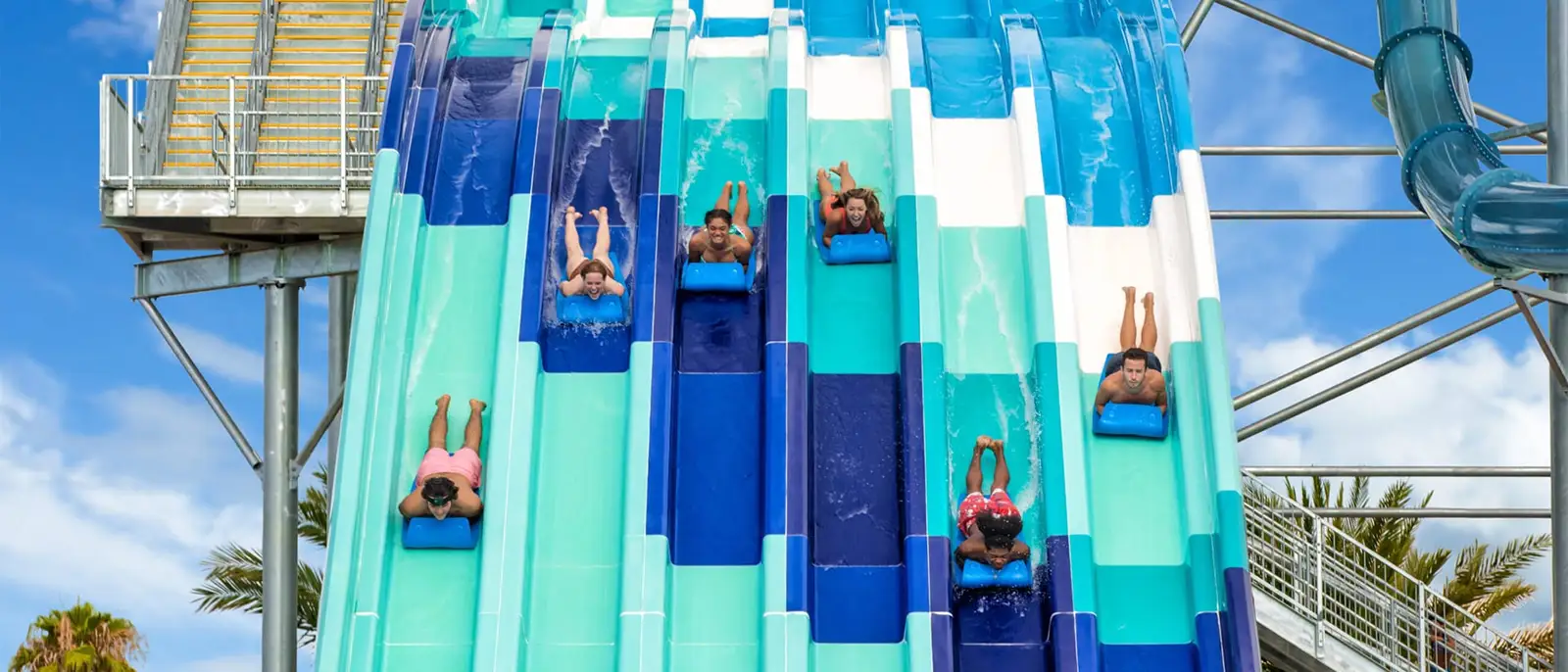 People riding the Reply Racers water slide at Island H2O Water Park