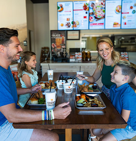 Family enjoying a meal at Cowboy Chicken