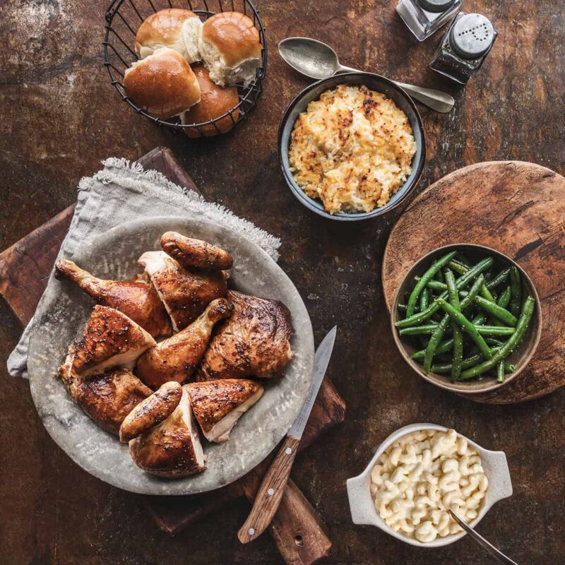 Plate of rotisserie chicken with stuffing and green beans from Cowboy Chicken