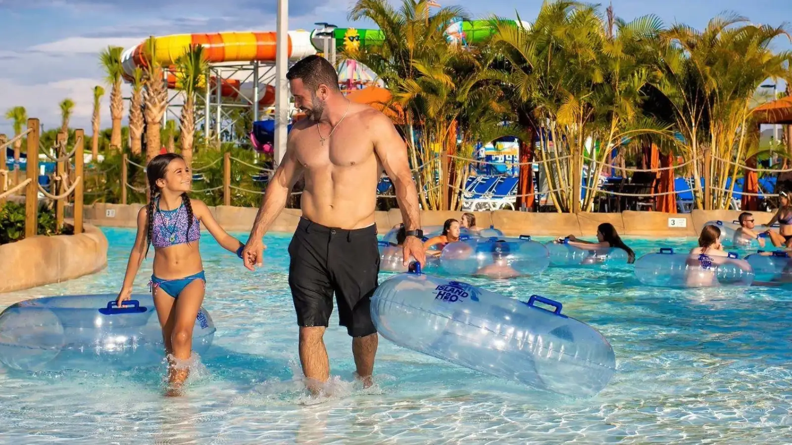 Father and daughter holding hands walking out of the lazy river at Island H2O Water Park
