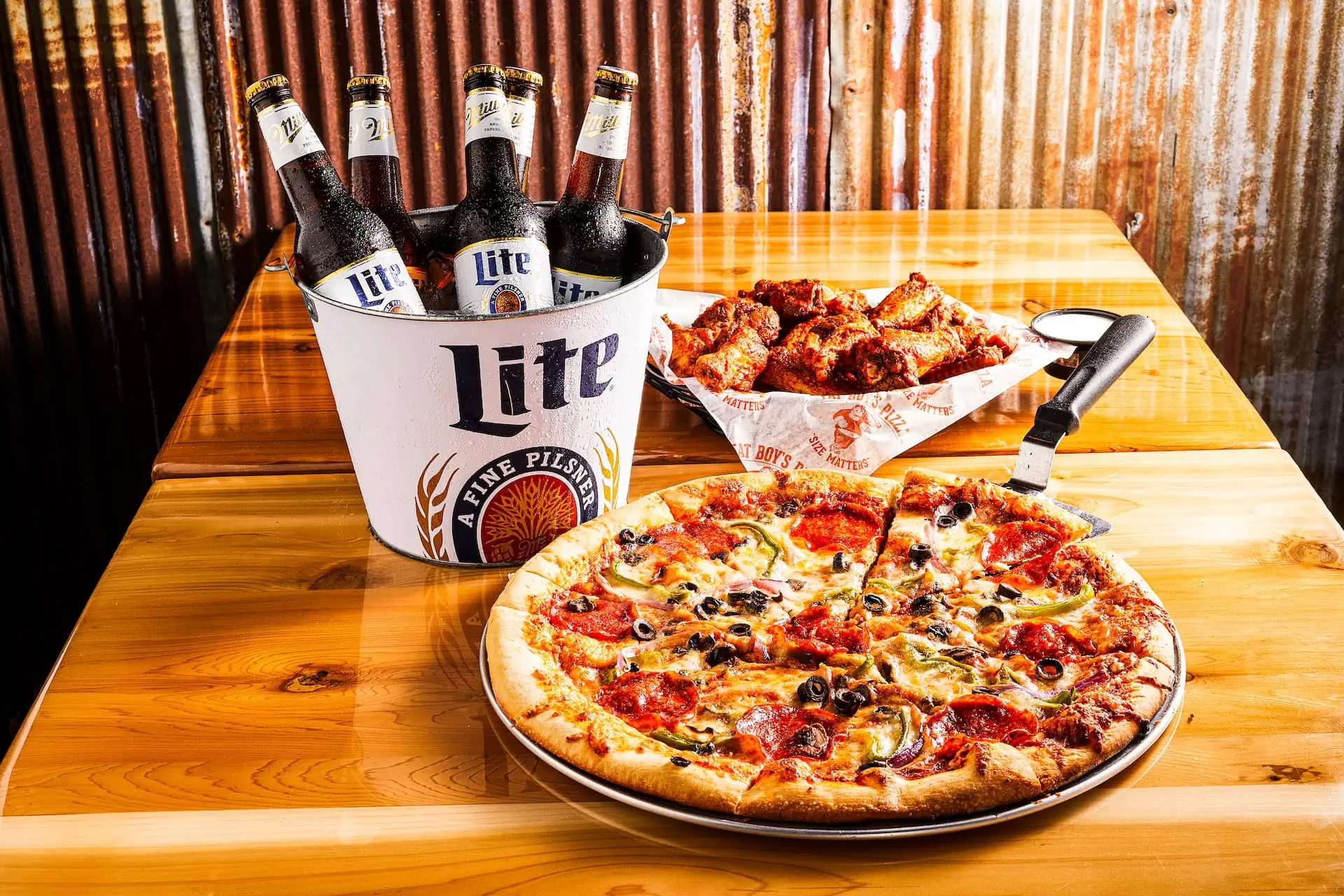 Fat Boy’s Pizza with wings and a beer bucket