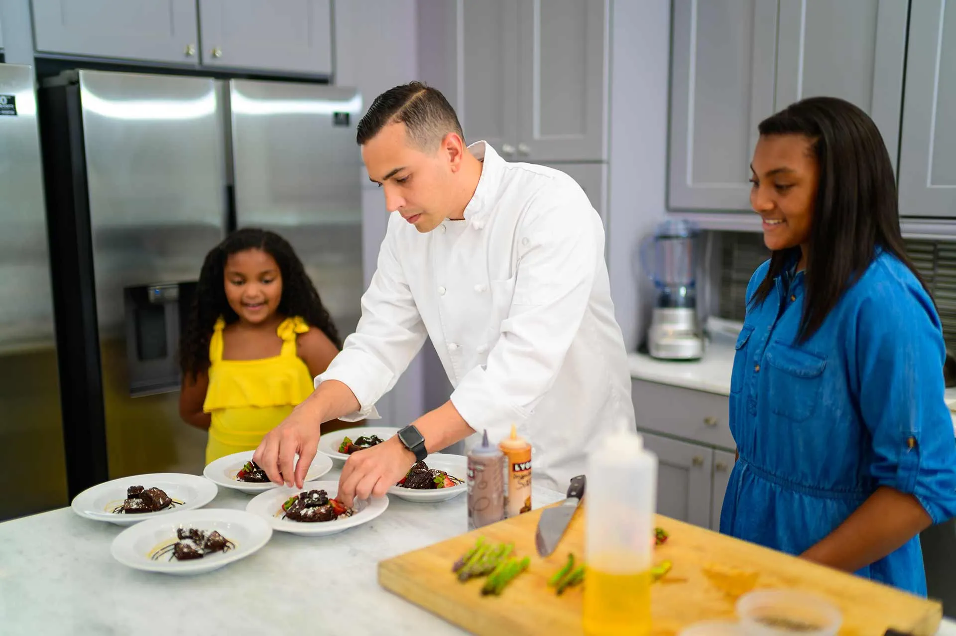 Chef preparing plates at a private chef experience