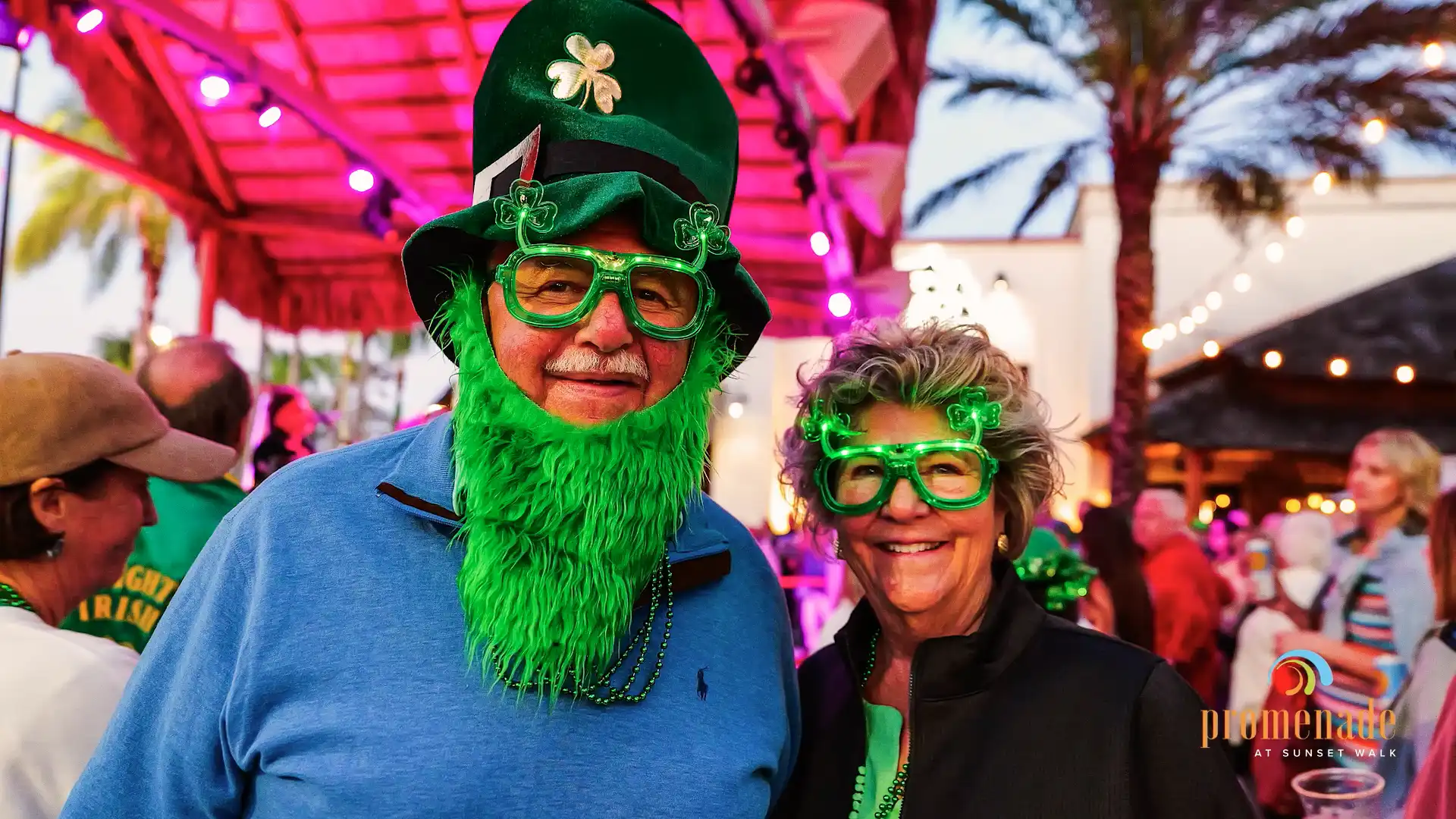 Couple in St. Patrick’s Day decor, including green glasses a long, green beard
