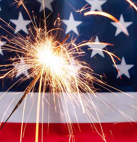 Sparkler in front of an American flag